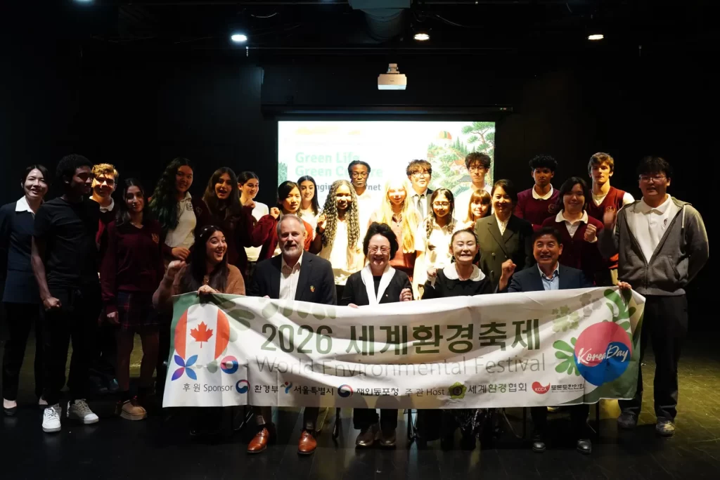 Metro Prep Students And Visiting Guests Pose For A Group Photo Holding A 2026 World Environmental Festival Banner.
